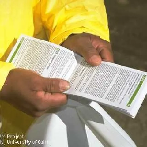 Reading pesticide label instructions. (Credit: Jack Kelly Clark)