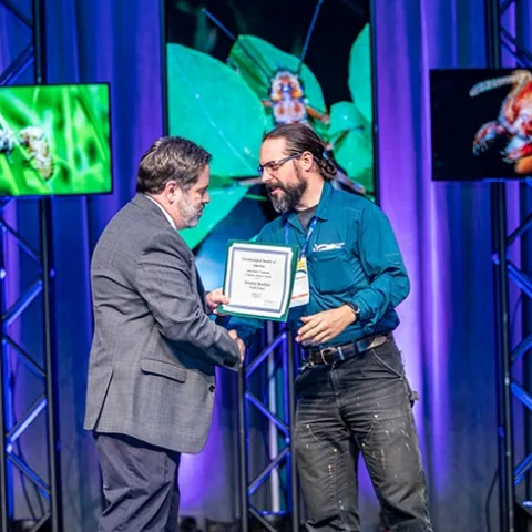 UC Davis doctoral candidate Brendon Boudinot walks on stage to receive the John Henry Comstock Award, given by the Pacific Branch, Entomolgical Society of America. (ESA Photo)