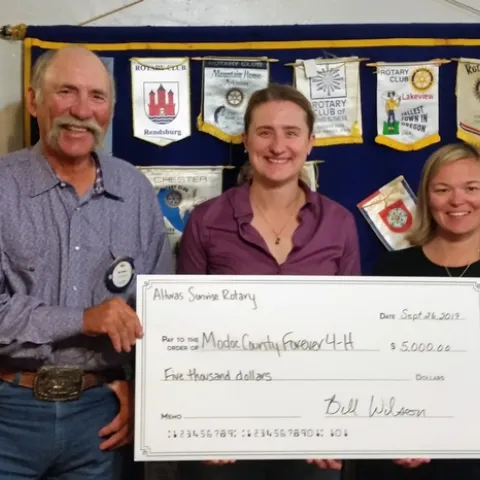Bill Wilson, Alturas Sunrise Rotary president, with UCCE director Laura Snell, and Sadie Camacho, 4-H program representative.