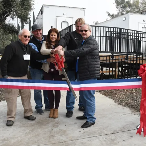 Ready to cut the ribbon (from left) are almond pollination consultant Robert Curtis of Carmichael, retired director of agricultural affairs, Almond Board of California; Brad Pankratz of Can-Am Apiaries, Orland; Jackie Parks-Burris of Jackie Park-Burris Queen Bees, Palo Cedro and a past president of California State Beekeepers' Association; Darren Cox, Logan, Utah, past president of American Honey Producers; and Kelvin Adee of Bruce, S.D., president of American Honey Producers.