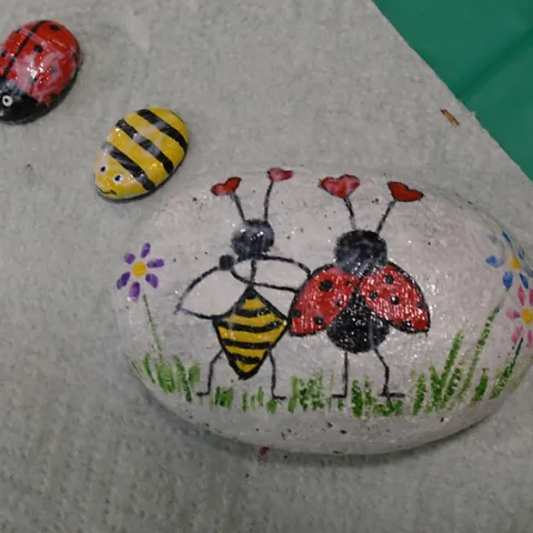 These rocks at the Bohart Museum of Entomology depict favorite insects: honey bees and ladybugs (lady beetles.) The larger rock, inspired by Valentine's Day, is titled "Love Bugs." (Photo by Kathy Keatley Garvey)