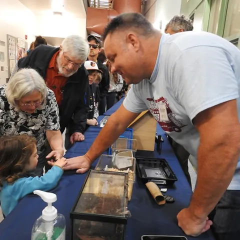 Martin Hauser, senior insect biosystematist with the Plant Pest Diagnostics Center, California Department of Food and Agriculture, introduces Madagascar hissing cockroaches to the crowd at the Bohart Museum of Entomology open house on Feb. 15 during UC Davis Biodiversity Museum Day. (Photo by Kathy Keatley Garvey)