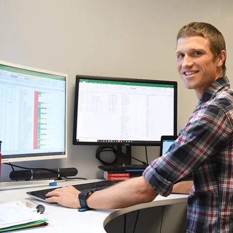 Cooperative Extension specialist Ian Grettenberger at his office in 73 Briggs Hall. (Photo by Kathy Keatley Garvey)