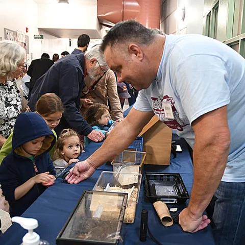 Martin Hauser, senior insect biosystematist with the Plant Pest Daignostics Branch, California Department of Food and Agriculture, shows Madagascar hissing cockroaches to visitors. (Photo by Kathy Keatley Garvey)