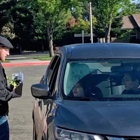 UC nutrition educators distributed "Lunch to Grow" packages to families at an elementary school drive-through lunch pick up. Each package contained a vegetable seedling, potting soil, a small pot and instructions for planting.