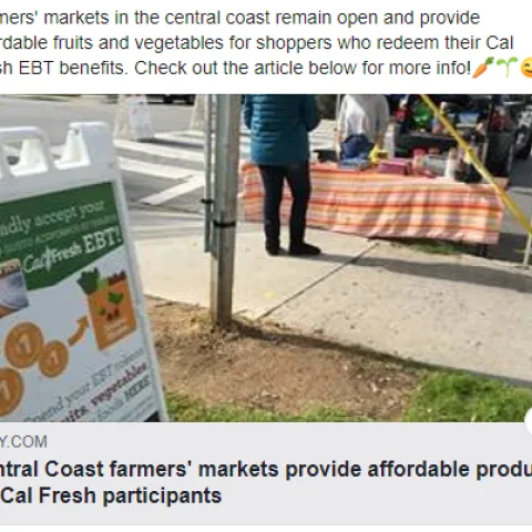 a sign posted at a farmers market that says We Gladly Accept EBT/CalFresh