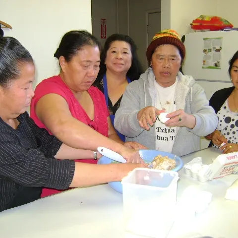 Sua Vang, center, teaches a class.