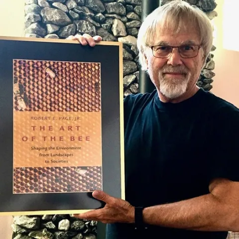 Honey bee geneticist and biologist Robert E. Page Jr. with his book,"The Art of the Bee."