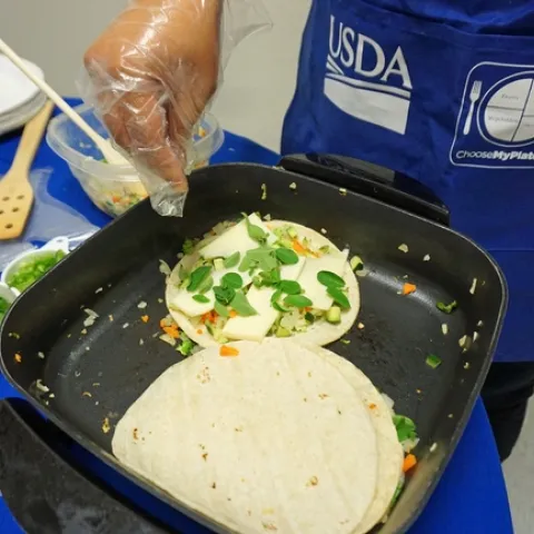 Adding green vegetables to quesadillas is a way to add nutrition to traditional staples.