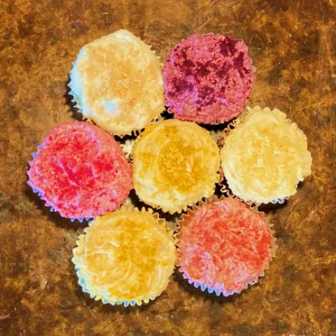 Fruit powder added to frosting on cupcakes.