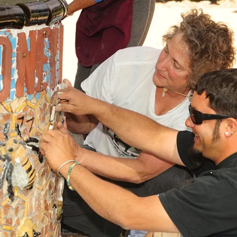 UC Davis entomology professor/artist Diane Ullman and Mark Rivera work on installing an art project at the Häagen-Dazs Honey Bee Haven at UC Davis. (Photo by Kathy Keatley Garvey)