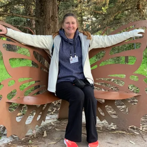 Hafner sitting on a monarch butterfly bench