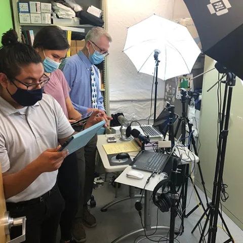UC Davis distinguished professor Walter Leal (far right) preparing for the chat session of the international symposium on olfaction and taste. Assisting him are students Efrain Vasquez (foreground) and Kelly Brandt.