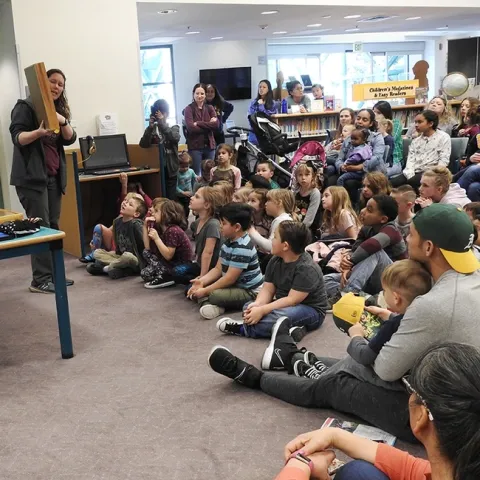 Tabatha Yang, the Bohart Museum of Entomology's education and outreach coordinator, shows a display of insects at a Vacaville Public Library event. The Bohart is in need of traveling display boxes and is raising funds. (Photo by Kathy Keatley Garvey)