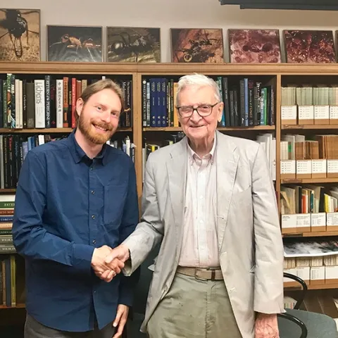 Marek Borowiec (left) shakes hands with E. O. Wilson at the Harvard Museum of Comparative Zoology (MCZ). Borowiec went on to receive his doctorate in entomology from UC Davis and is now an assistant professor at the University of Idaho.