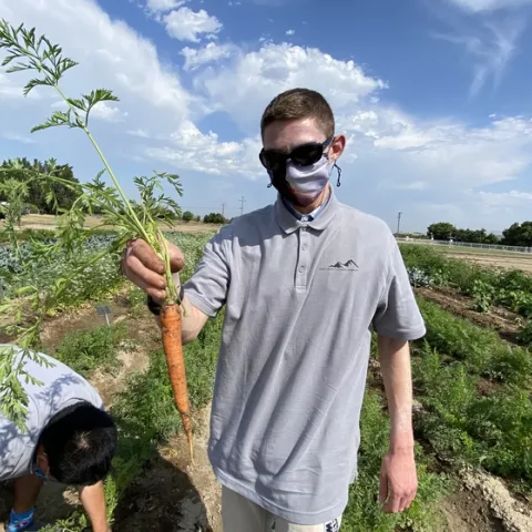 Student holding a carrot at South Coast REC