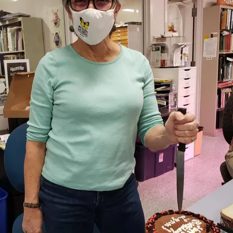 Lynn Kimsey, director of the Bohart Museum of Entomology, prepares to cut her birthday cake. (Photo by Tabatha Yang)