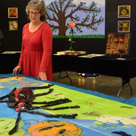 In this 2015 art show photo, UC Davis professor Diane Ullman looks over the work that her students created in her Entomology 001 class, "Art, Science and the World of Insects." (Photo by Kathy Keatley Garvey)