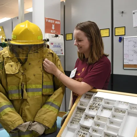UC Davis forest entomologist and doctoral student Crystal Homicz assists a fire beetle demonstration at a 2018 Bohart Museum of Entomology open house. The fire beetles are in the genus Melanophila and are sensitive to smoke and heat from smoldering trees after a fire. (Photo by Kathy Keatley Garvey)