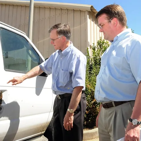 In this image, taken Aug. 1, 2008, Extension apiculturist Eric Mussen (left) talks to vanpool driver Keir Reavie, head of the Biological and Agriculture Sciences Department at Shields Library, about the bees that "hitched" a ride on a commuter van traveling from El Cerrito to the UC Davis campus. (Photo by Kathy Keatley Garvey)