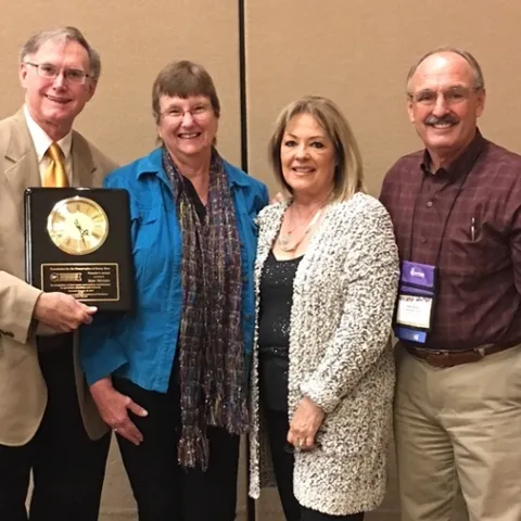 Eric Mussen (far left) received the prestigious Founders' Award from the Foundation for the Preservation of Honey Bees at the 75th annual American Beekeeping Federation conference in Reno in 2018. With him are his wife, Helen, and close friends Christine and Gene Brandi of Los Banos. Gene, the 2018 president of the American Beekeeping Federation, presented him with the award.