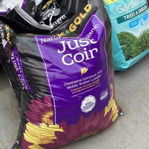 black and purple plastic bag of coir
