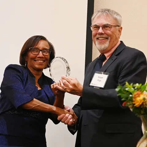 Helene Dillard, dean of the UC Davis College of Agricultural and Environmental Sciences, presents the Exceptional Emeriti Faculty Award to honey bee geneticist Robert E. Page Jr. (Photo by Kathy Keatley Garvey)
