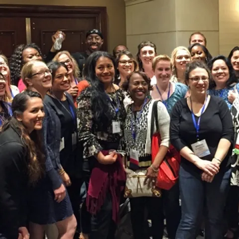 A crowd of smiling men and women.