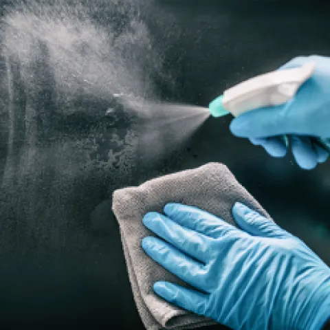 Disinfecting a surface.