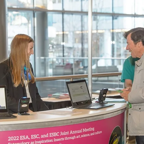 UC Davis distinguished professor Frank Zalom, an Honorary Member of ESA and a past president, arrives at the registration desk. (ESA Photo)