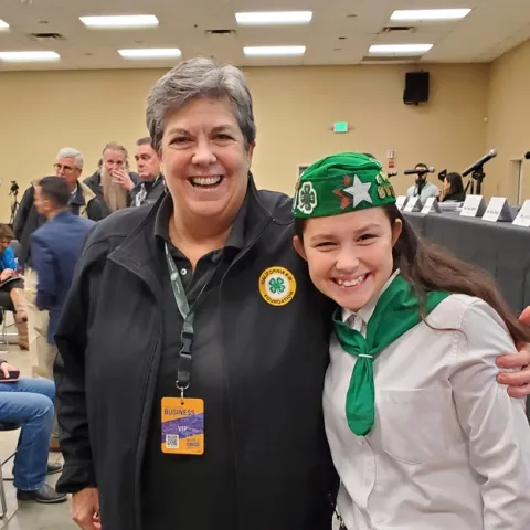 Humiston is wearing a black jacket with a California 4-H Foundation emblem. Kambree is wearing her green and white 4-H uniform.