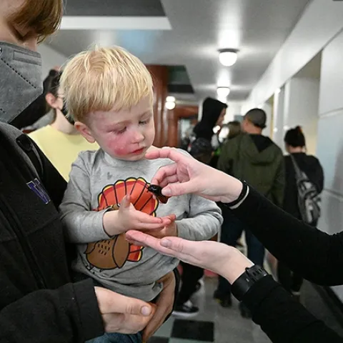 Finn Jensen, 2 1/2, awaits the placement of a Madagascar hissing cockroach in his hand. (Photo by Kathy Keatley Garvey)