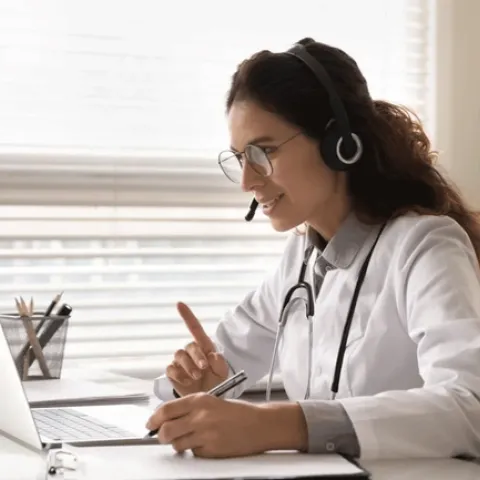 A doctor consults over a laptop