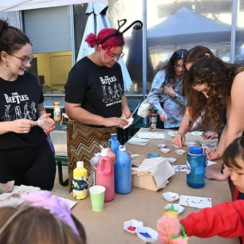 UC Davis entomologists, first-year doctoral students Abigail Lehner (front) of the Neal Williams lab, and Iris Quayle of the Jason Bond lab, staff the Maggot Art table at Briggs Hall. (Photo by Kathy Keatley Garvey)
