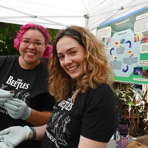 Doctoral candidate Taylor Kelly (right), served as coordinator of the Roach Races. With her is doctoral student Iris Quayle. Both served as announcers and roach handlers. (Photo by Kathy Keatley Garvey)
