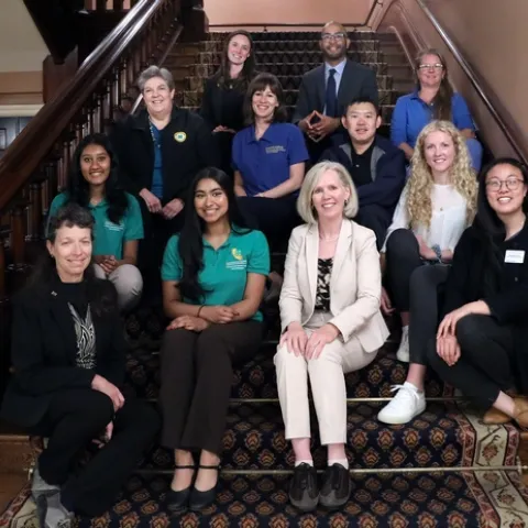 A group of people sit on a staircase.
