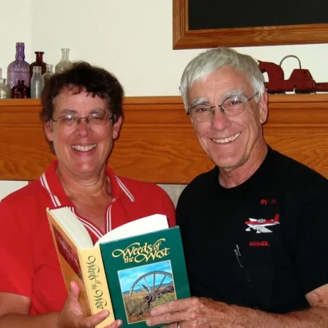 Dave Cudney holds a "Weeds of the West" book with his sister.