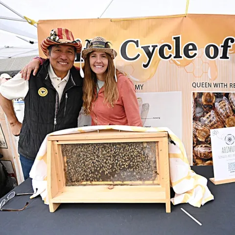 Master Beekeeper Sung Lee of Castro Valley, known worldwide on social media as "Sung Lee The Bee Charmer," displayed his observation hive at the California Honey Festival. With him is fellow CAMBP member Leandra Hale of Lake Tahoe. (Photo by Kathy Keatley Garvey)