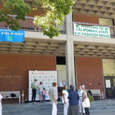 Picture of Wellman Hall at UC Davis. Outside is an area where students can take pictures agains a big 4-H backdrop.