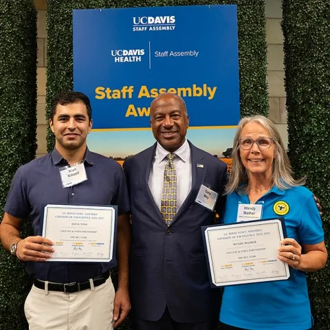 UC Davis Chancellor Gary May congratulates the California Master Beekeeper Program. With him are co-program managers Wendy Mather and Kian Nikzad. (Photo by Kathy Keatley Garvey)