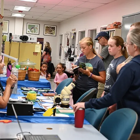CC Edwards (left), a doctoral student and mosquito research in the lab of UC Davis medical entomologist-geneticist Geoffrey Attardo, answers questions about mosquitoes. (Photo by Kathy Keatley Garvey)