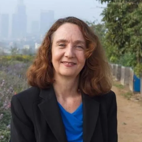 Surls stands beside trees