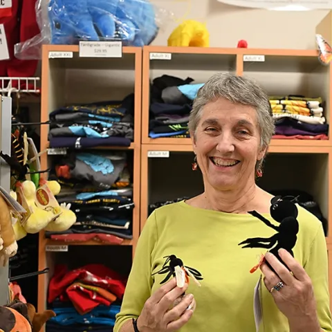 UC Davis distinguished professor Lynn Kimsey, director of the Bohart Museum of Entomology, holds some of the stocking stuffers available in the Bohart git shop. (Photo by Kathy Keatley Garvey)