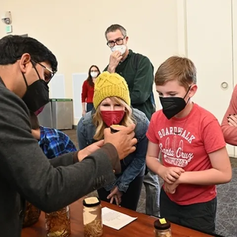 Nematologist Shahid Siddique, associate professor, UC Davis Department of Entomology and Nematology, chats with visitors at a UC Davis Biodiversity Museum Day. (Photo by Kathy Keatley Garvey)