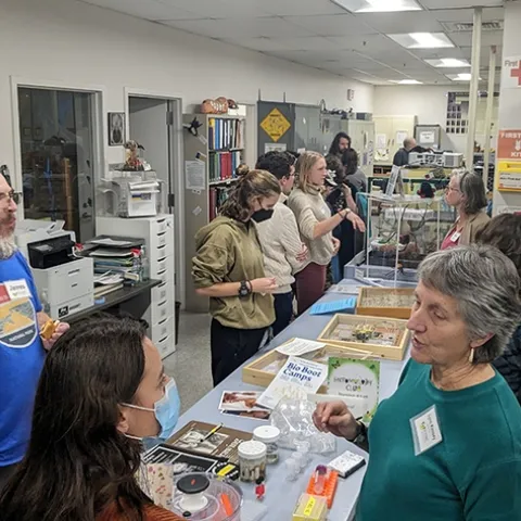 Lynn Kimsey (right foreground), director of the Bohart Museum of Entomology, and James Starrett (left) postdoctoral research scientist with the Jason Bond lab, talk to UC Davis scientists.