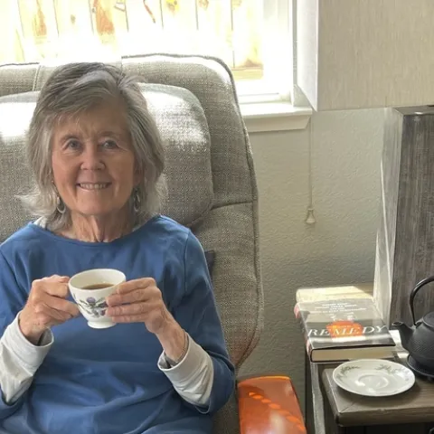 Author with a cup of tea and a good book.