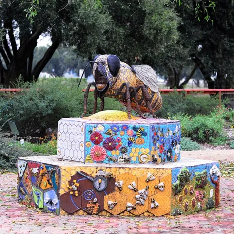 A ceramic-mosaic sculpture, "Miss Beehaven," anchors the UC Davis Bee Haven. It is the work of self-described "rock artist" Donna Billick of Davis. (Photo by Kathy Keatley Garvey)