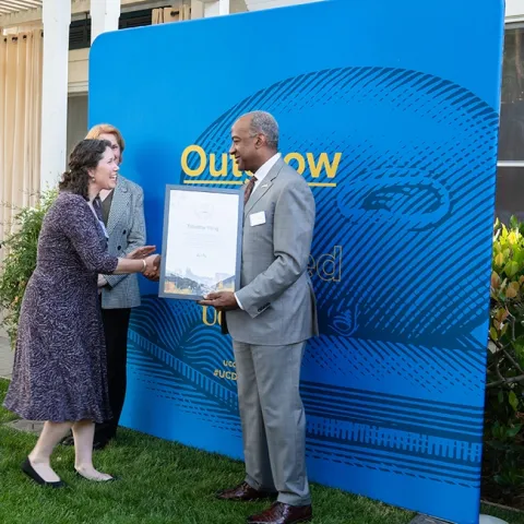 Tabatha Yang, education and outreach coordinator of the Bohart Museum of Entomology, greeting UC Davis Chancellor Gary May. (Photo by Anjie Cook)