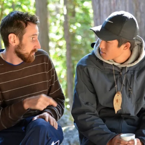 Adult Volunteer chatting with a youth in the On The Wild Side 4-H program.