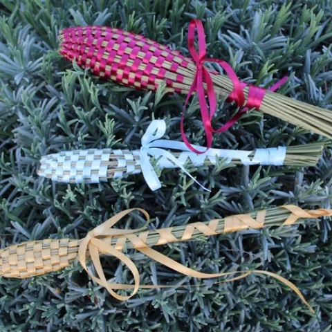 Three lavender wands resting on a lavender plant.